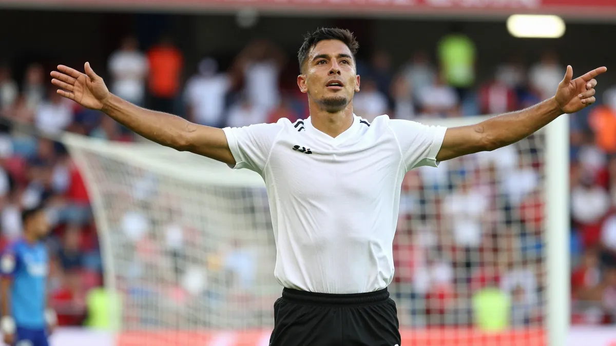 A tight action crop of an anonymous Querétaro player, aged 25-30, in a midfielder role, with a clean white jersey and...