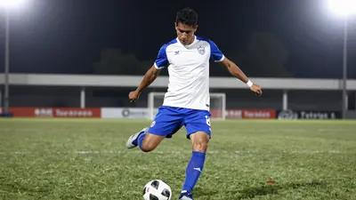 A photorealistic image of an anonymous Querétaro player, aged 25-30, wearing a white jersey with blue sleeves and a blue...